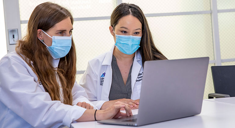 doctors on a computer