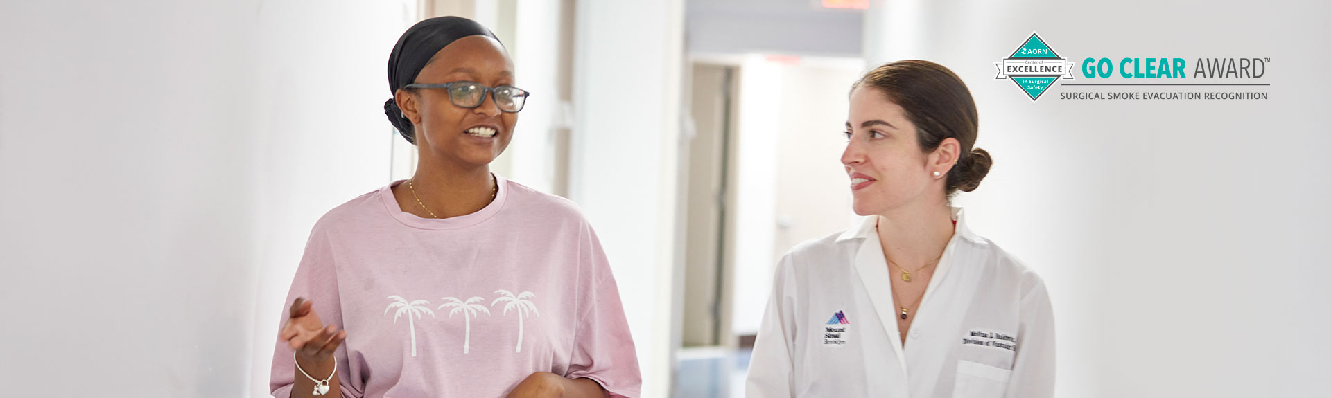 doctor walking patient down hospital hallway