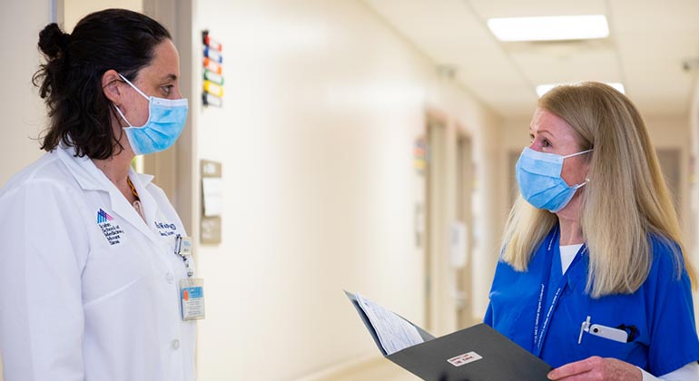 nurse and doctor in conversation