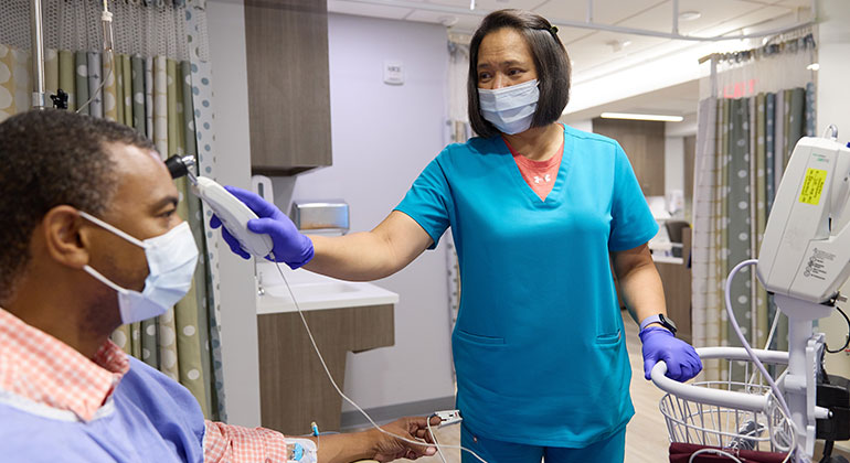nurse taking patient vitals