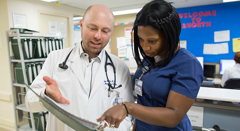 Nurse and doctor review patient chart