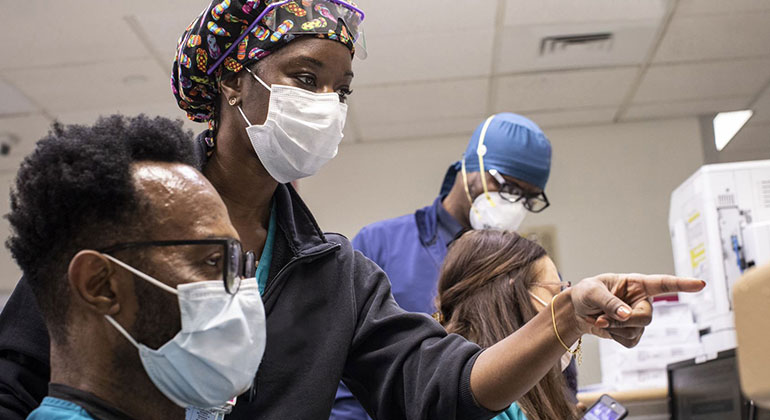 Nurses working at nursing station in hospital