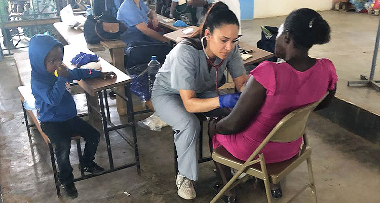 Student nurse treating patients abroad