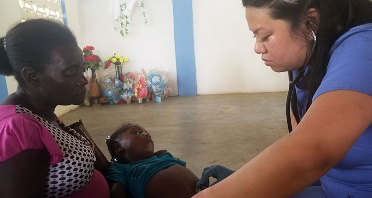 Student nurse treating patients abroad