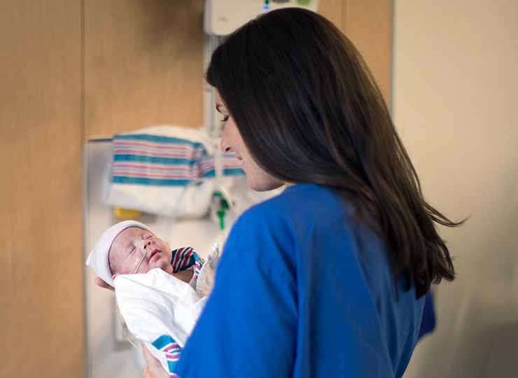 Photo of Image of nurse holding baby