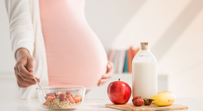 image woman holding pregnant stomach