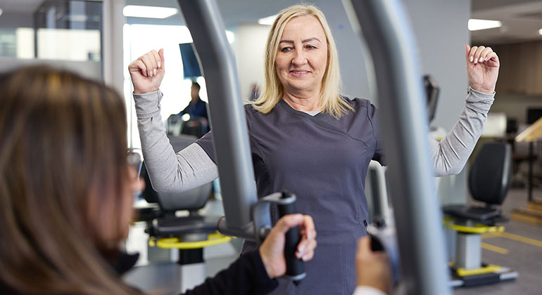 patient being trained on exercising machine