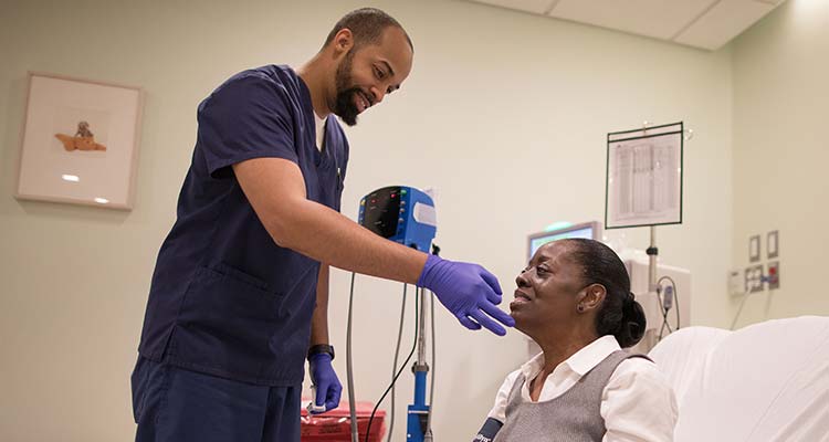 Image of male nurse attending patient