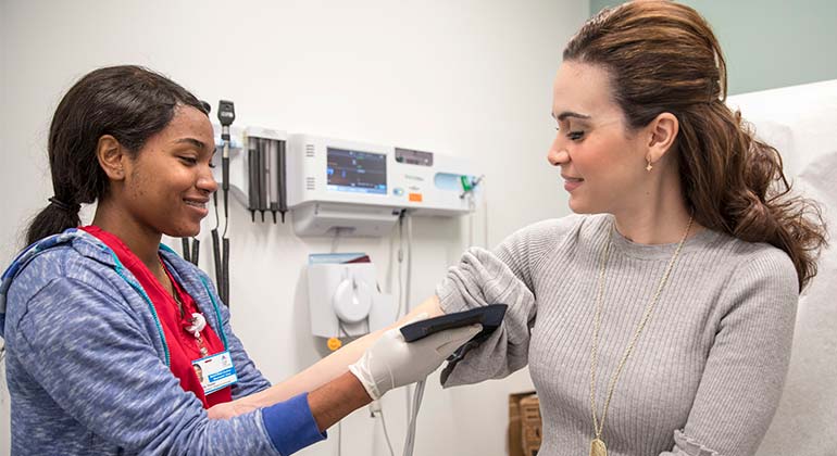 Image of nurse examining patient