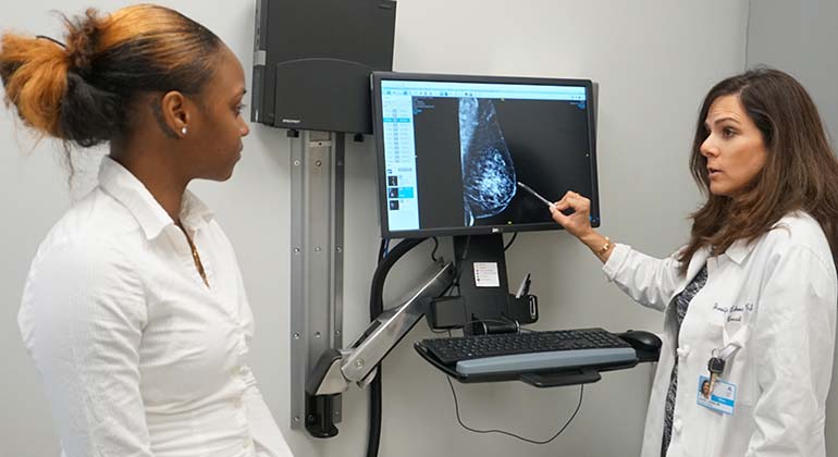 Image of doctor talking to female patient