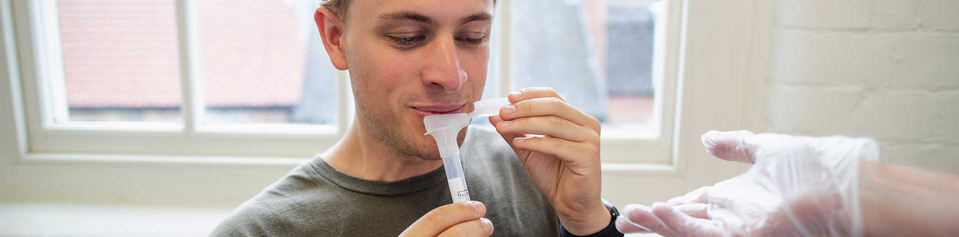 Man performing saliva test