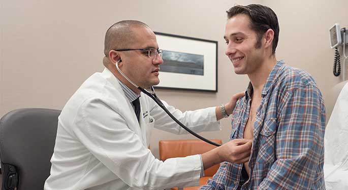 Male physician examining a male patient