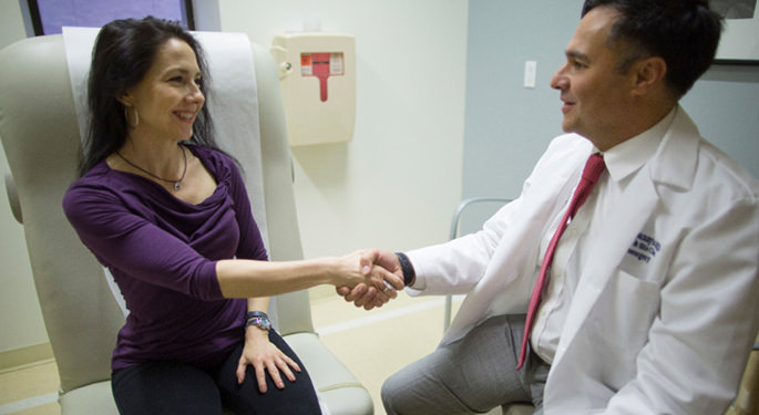 image of Dr. Hadjipanayis with patient in consultation room
