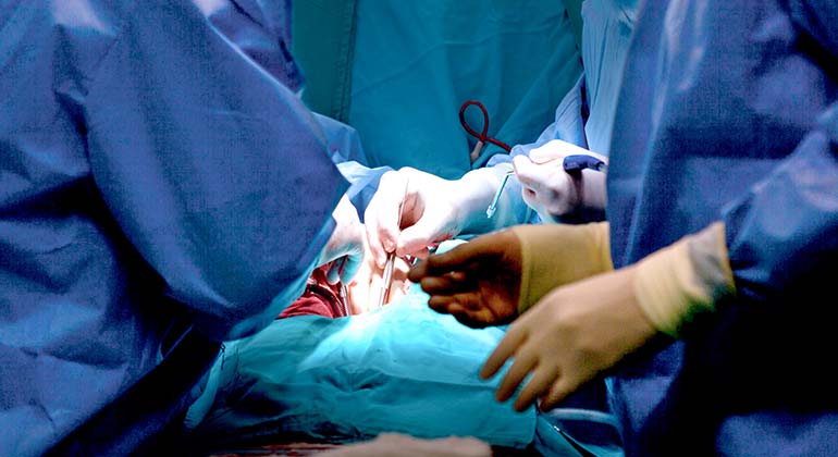 Surgeons performing heart surgery