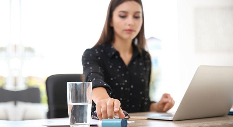 Woman grabbing inhaler