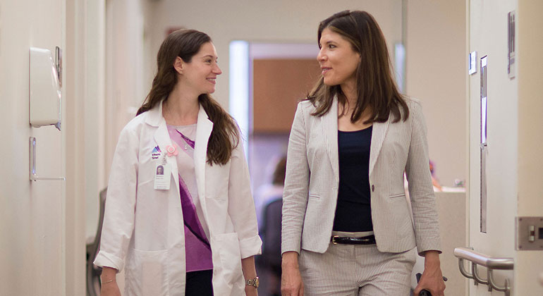 Doctor and patient walking in hallway