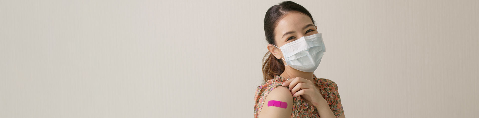 Masked patient with band aid from vaccine shot