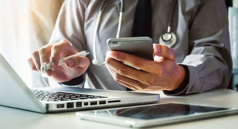 Patient on computer and phone