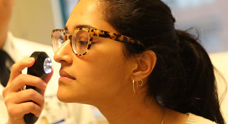 Female having face examined by a dermatologist