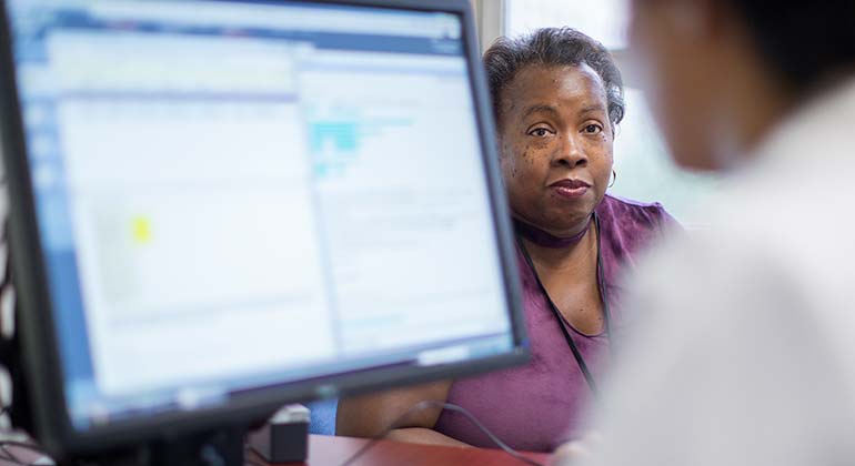 Patient with doctor and computer screen