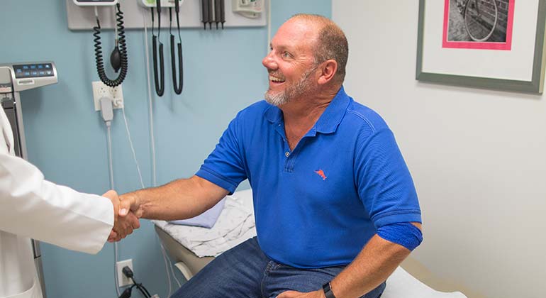 Patient shaking doctor’s hand