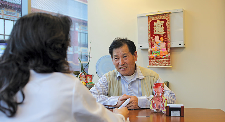 Image of a female doctor and male patient talking at the Mount Sinai Doctors Specialty Practice in New York City