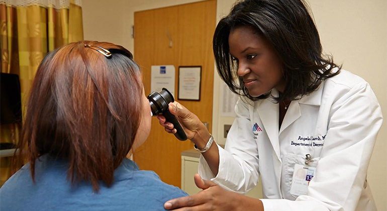 Image of a female doctor giving an eye examination to a female patient