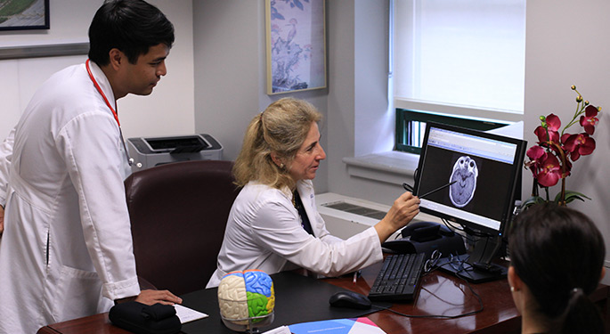 doctor explaining to young team member information from a monitor
