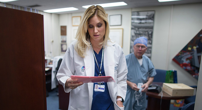 Doctor looking at clipboard