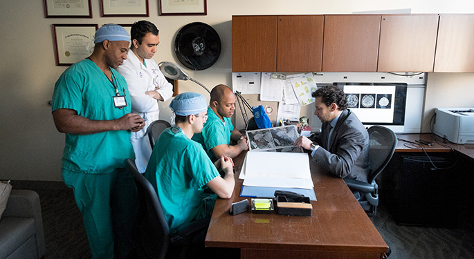 Team of doctors at a desk, talking