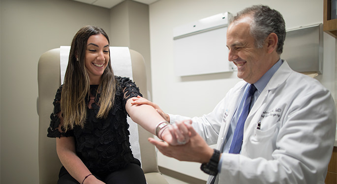  Image of Andrew C. Hecht, Chief of Spine Surgery and Director of Spine Center, with patient during office visit