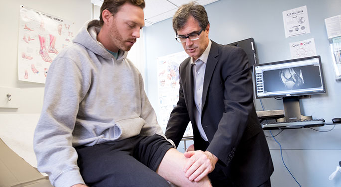 Image of Dr. James Gladstone with patient, during office visit