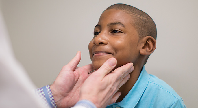 Young boy, being examined by physician during office visit