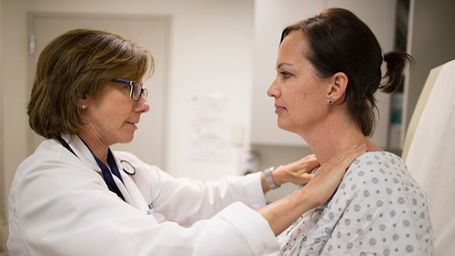 Doctor touching woman