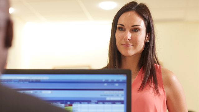 Woman patient checking in and view of computer screen