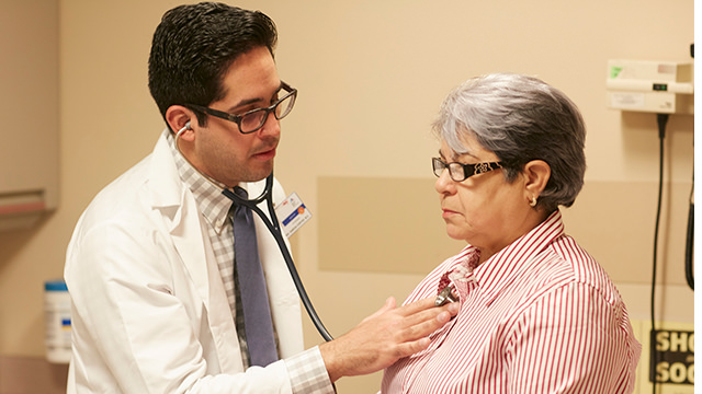 Doctor listening to patient heart