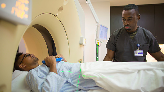 Technician preparing patient for MRI