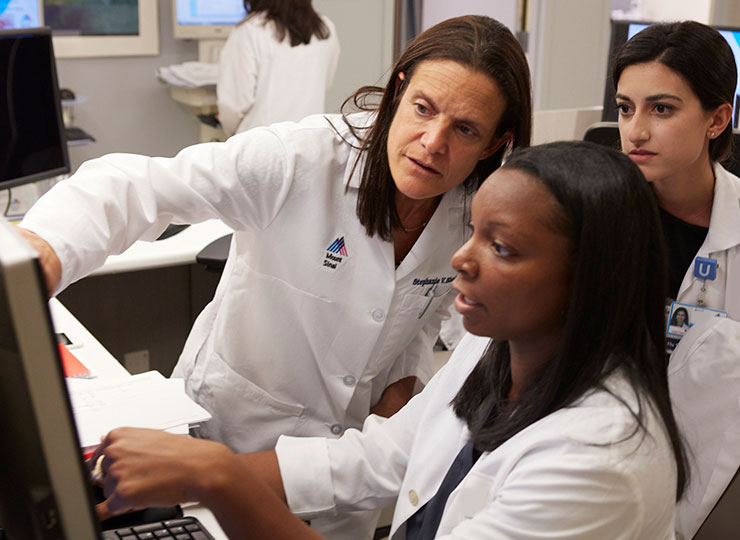 Photo of Doctors looking at computer