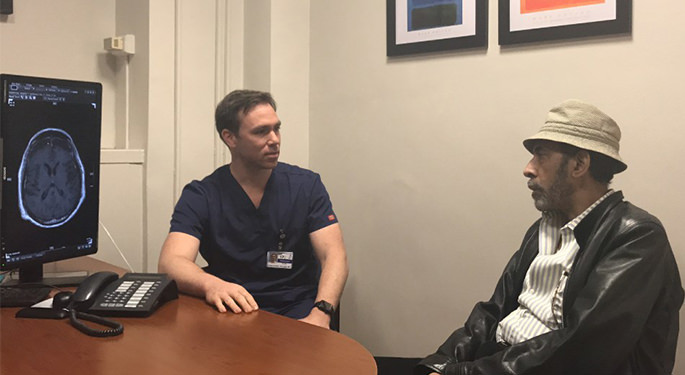 image of physician conversing with patient in consultation room