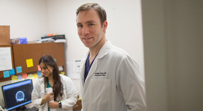 image of physician walking out of office with physician in the background