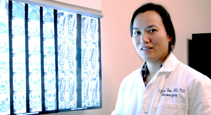 image of Dr. Zou in front of various x-rays