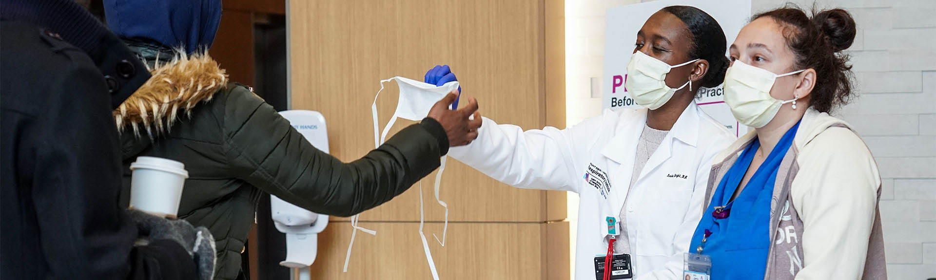 Doctors giving patient a mask