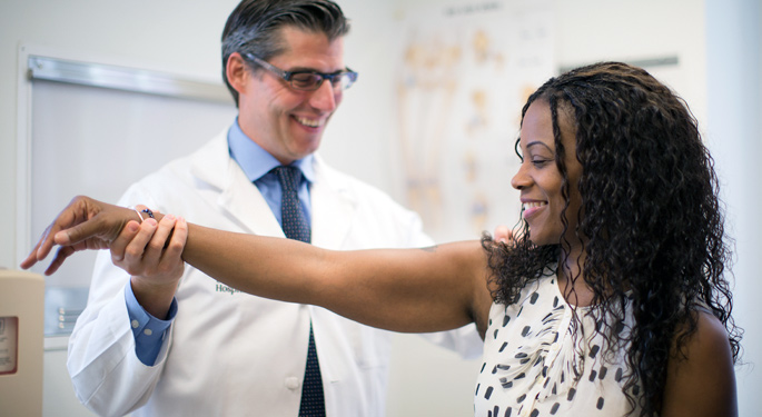 Orthopedic surgeon, Dr. Bradford Parsons, with female shoulder injury patient