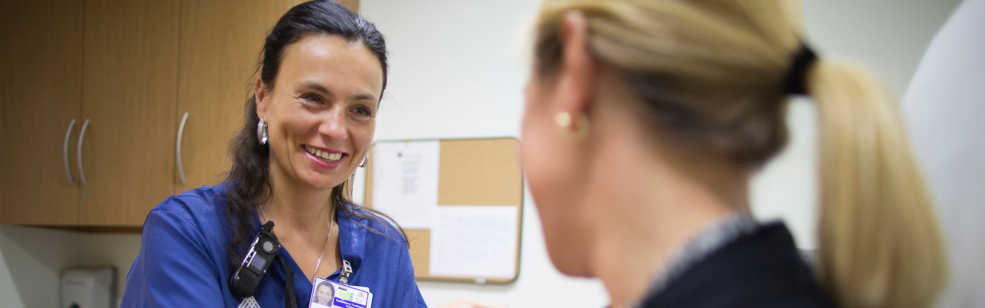 Nurse talking to woman patient