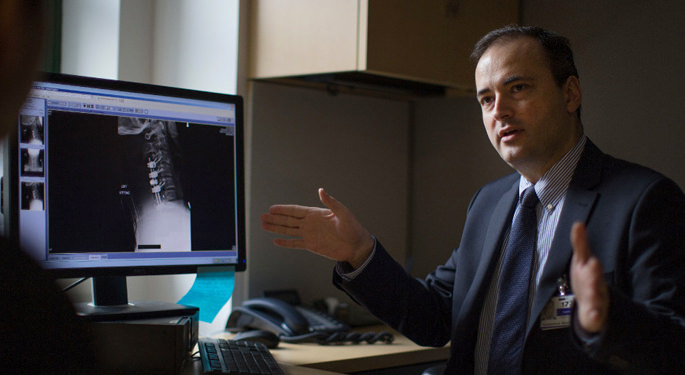 image of Dr. Margetis reviewing x-ray in office
