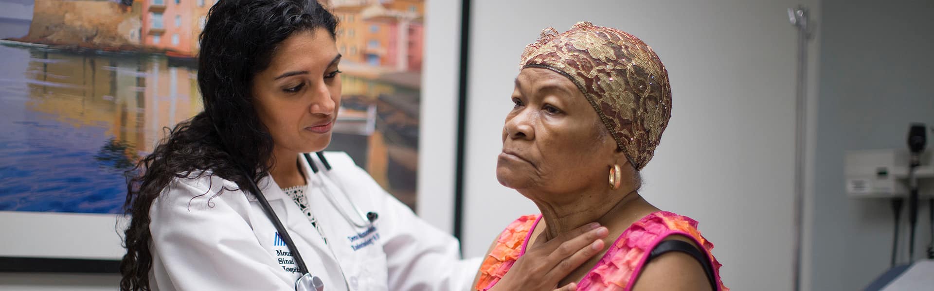 Dr. Deena Adimoolam examines patient