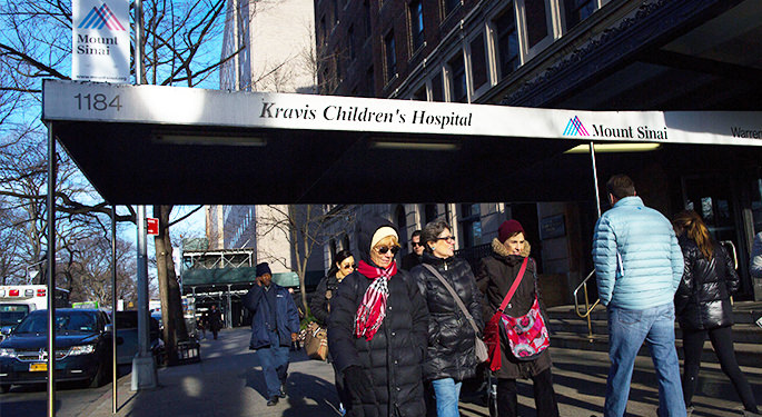 People in front of hospital entrance