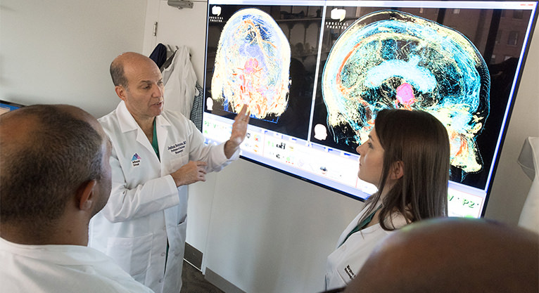 medical staff explaining information from a projection screen