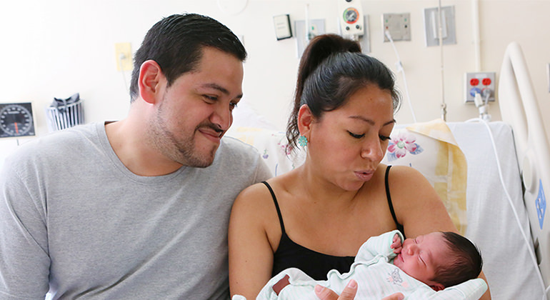 Couple holding newborn baby