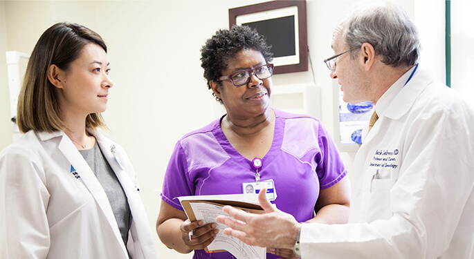 Two doctors with nurse